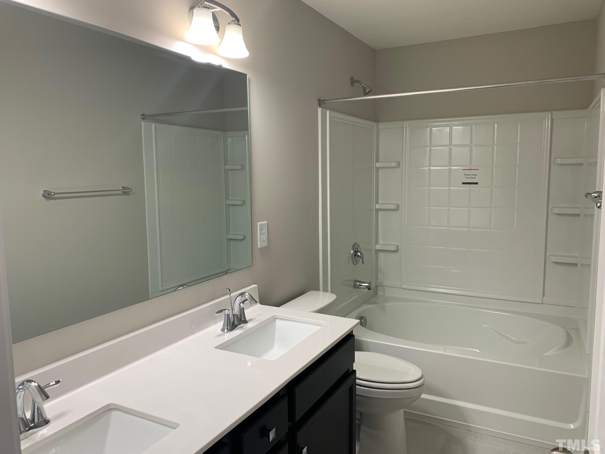 7104 Commodity Court Mebane, NC 27302 - Photo 25 of 32 a bathroom with a sink a toilet and shower