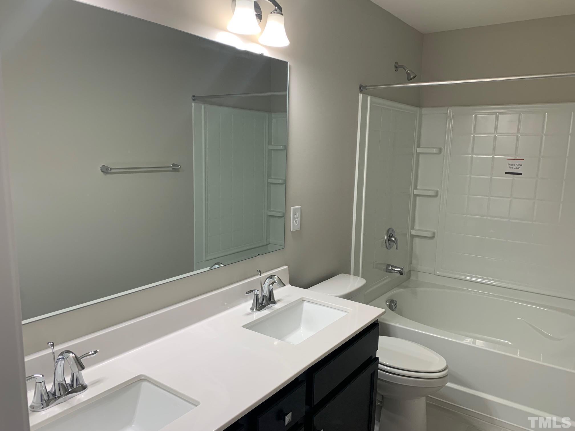 7104 Commodity Court Mebane, NC 27302 - Photo 28 of 32 a bathroom with a sink a toilet and shower
