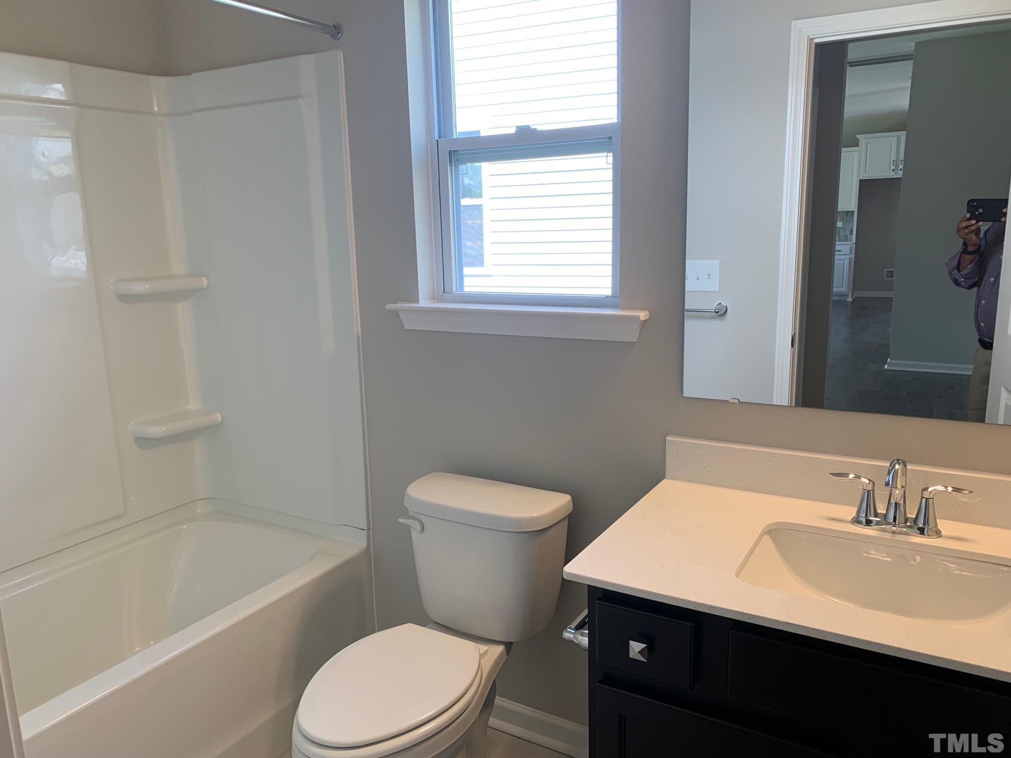 7104 Commodity Court Mebane, NC 27302 - Photo 5 of 32 a bathroom with a sink a toilet and a bathtub