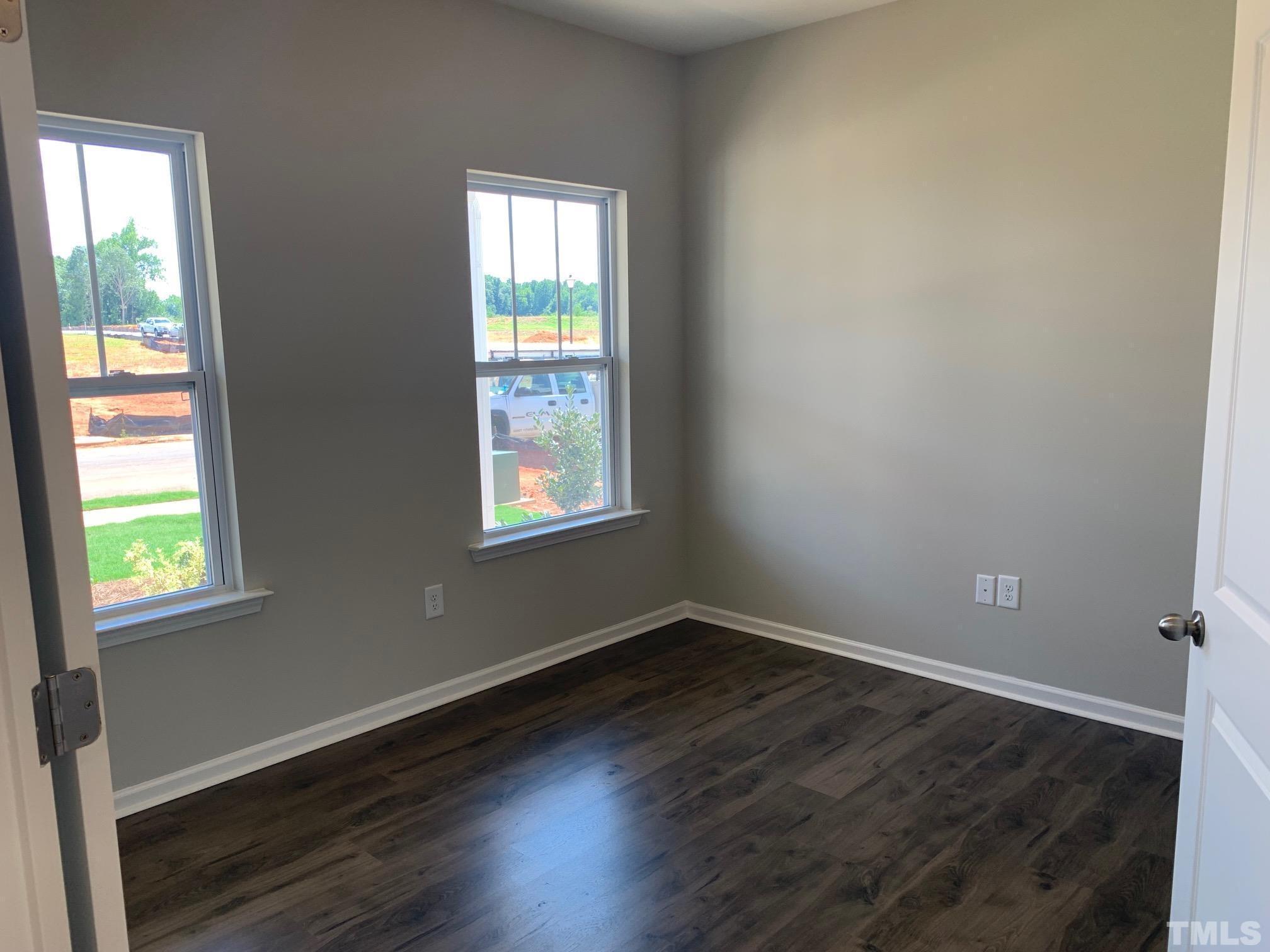7104 Commodity Court Mebane, NC 27302 - Photo 8 of 32 an empty room with wooden floor and windows