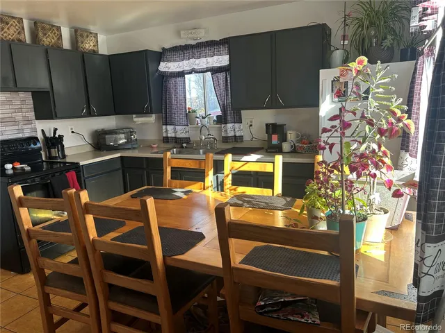 a kitchen with a table chairs and cabinets