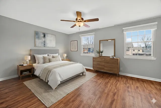 a bedroom with a bed and a large window