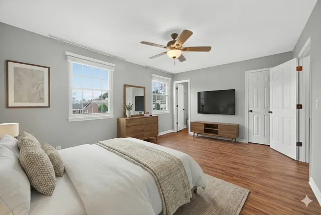 a bedroom with a bed and a flat screen tv