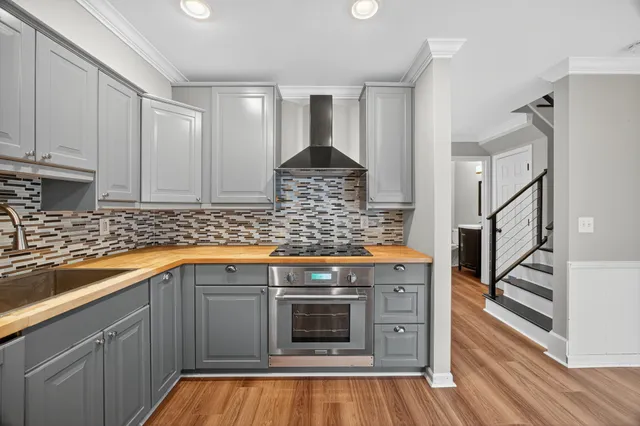 a kitchen with stainless steel appliances granite countertop a stove and cabinets