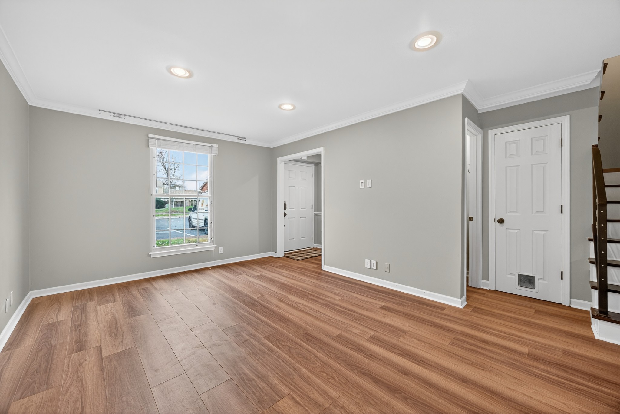 1011 Murfreesboro Road, Unit J2 Franklin, TN 37064 - Photo 6 of 29 a view of an empty room with wooden floor and a window
