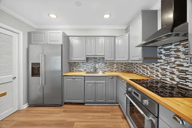 a kitchen with kitchen island granite countertop a sink and cabinets