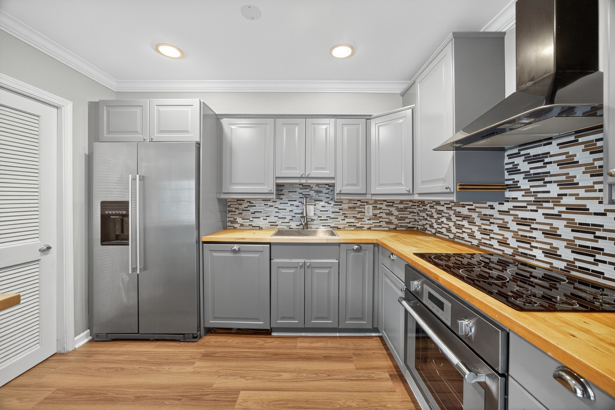 1011 Murfreesboro Road, Unit J2 Franklin, TN 37064 - Photo 8 of 29 a kitchen with kitchen island granite countertop a sink and cabinets