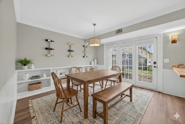 a view of a dining room with furniture and wooden floor