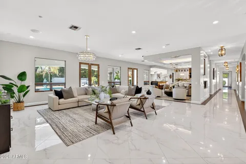 a living room with furniture and kitchen view