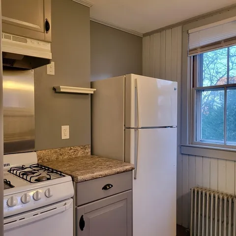 a kitchen with a stove and a refrigerator
