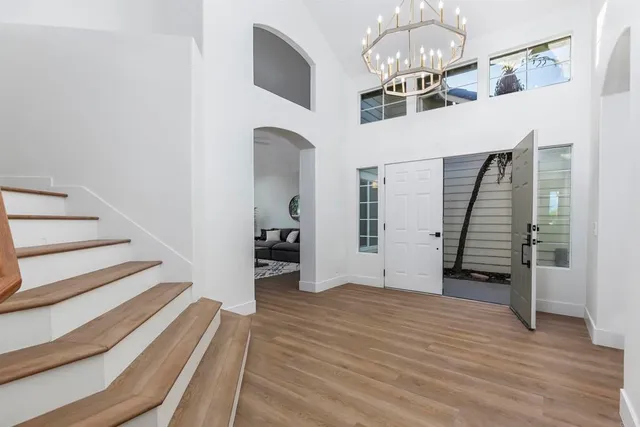 a view of a livingroom with wooden floor and staircase