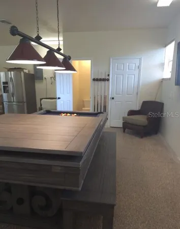 a view of an house with backyard and a tree