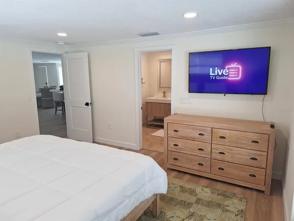 a bedroom with a bed and a dresser