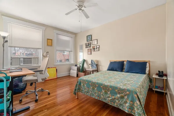 a bedroom with a bed a table and chair