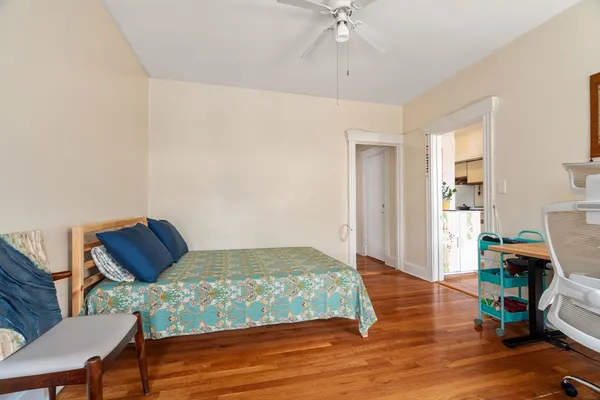 a bedroom with a bed and wooden floor