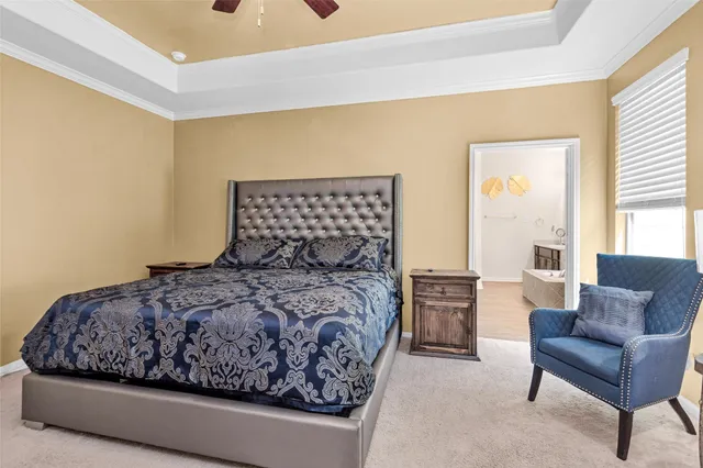 a bedroom with a large bed and two couches chair