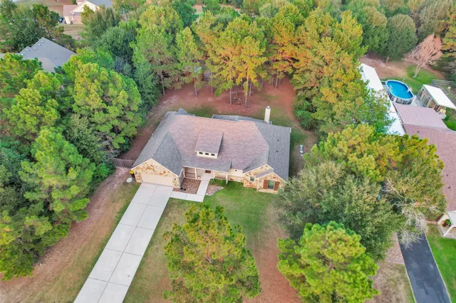 an aerial view of a house with a yard