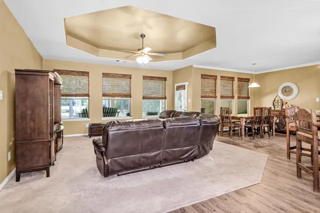 a living room with furniture windows and wooden floor
