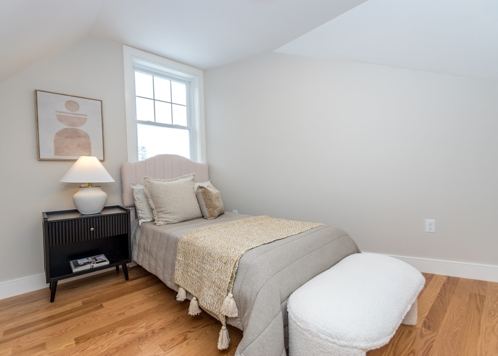89 Hardy Pond Road Waltham, MA 02451 - Photo 24 of 39 a bedroom with a bed and wooden floor