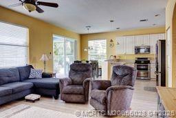 2120 Northwest Marsh Rabbit Lane Jensen Beach, FL 34957 - Photo 13 of 34 a living room with furniture and a large window