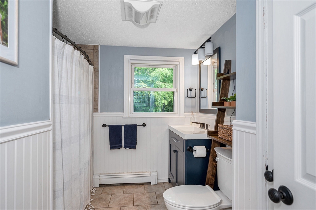 4 Governor Saltonstall Road Billerica, MA 01821 - Photo 9 of 25 a bathroom with a toilet a sink and a mirror