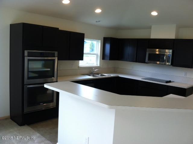 1198 Camp Ridge Lane Middleburg, FL 32068 - Photo 2 of 7 a kitchen with a sink and a microwave