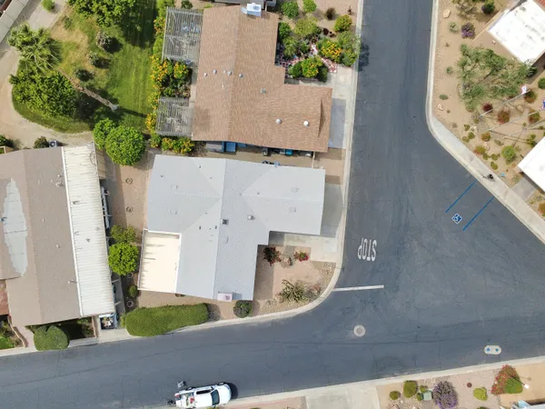an aerial view of a house with a yard