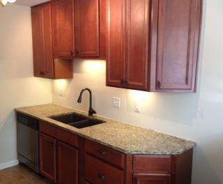 1018 General George Patton Road, Unit 1018 Nashville, TN 37221 - Photo 4 of 8 a kitchen with granite countertop a sink and cabinets