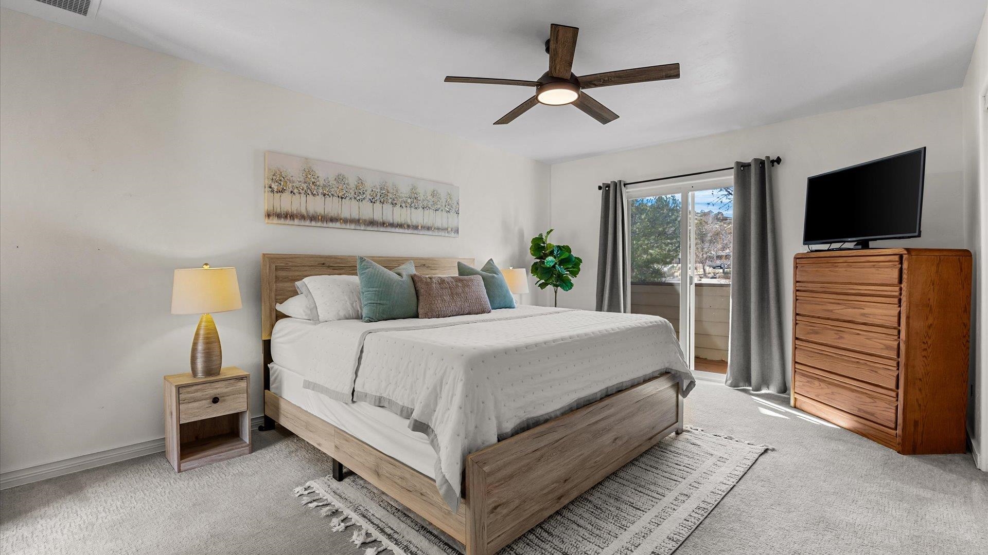 397 Ridge Cir Drive, Unit 3 Grand Junction, CO 81507 - Photo 17 of 28 a bedroom with a bed and a flat screen tv