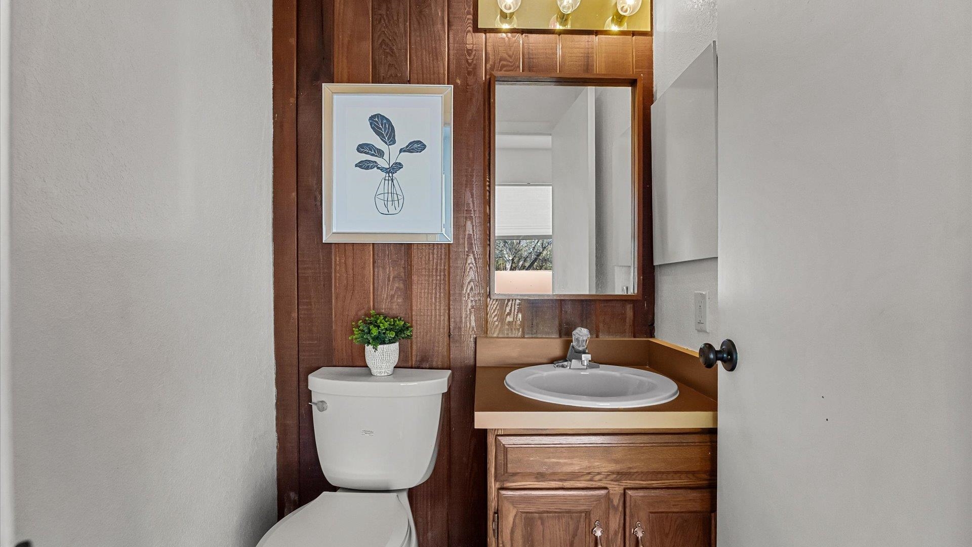 397 Ridge Cir Drive, Unit 3 Grand Junction, CO 81507 - Photo 5 of 28 a bathroom with a toilet a sink and mirror