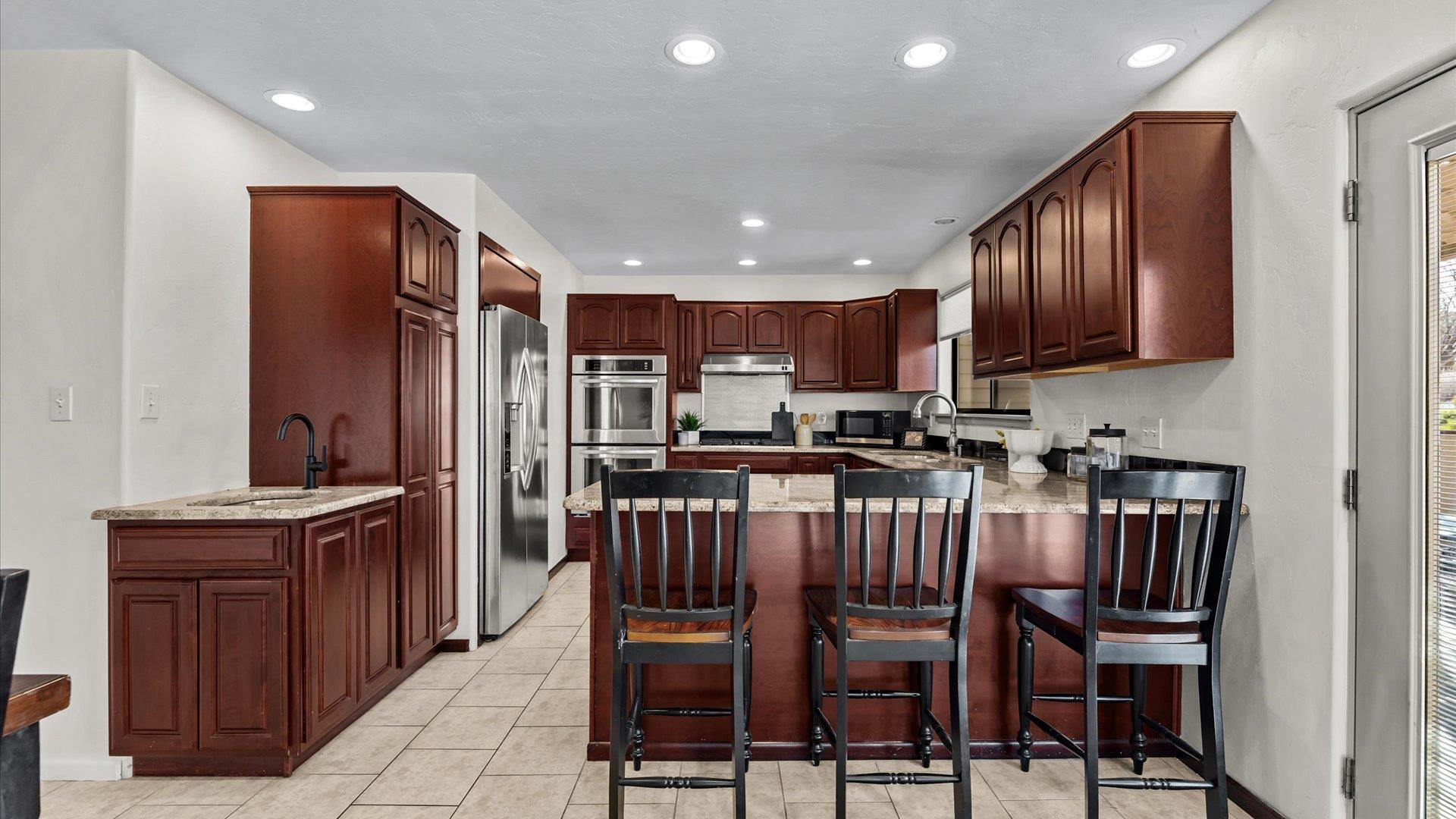 397 Ridge Cir Drive, Unit 3 Grand Junction, CO 81507 - Photo 7 of 28 a kitchen with granite countertop wooden cabinets and stainless steel appliances
