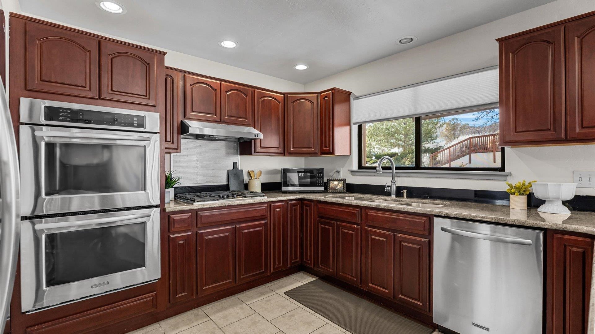 397 Ridge Cir Drive, Unit 3 Grand Junction, CO 81507 - Photo 8 of 28 a kitchen with granite countertop a sink stainless steel appliances and cabinets