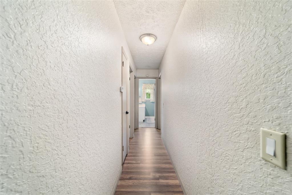 15755 Southwest 90th Avenue Dunnellon, FL 34432 - Photo 24 of 55 a view of a hallway with wooden floor and staircase