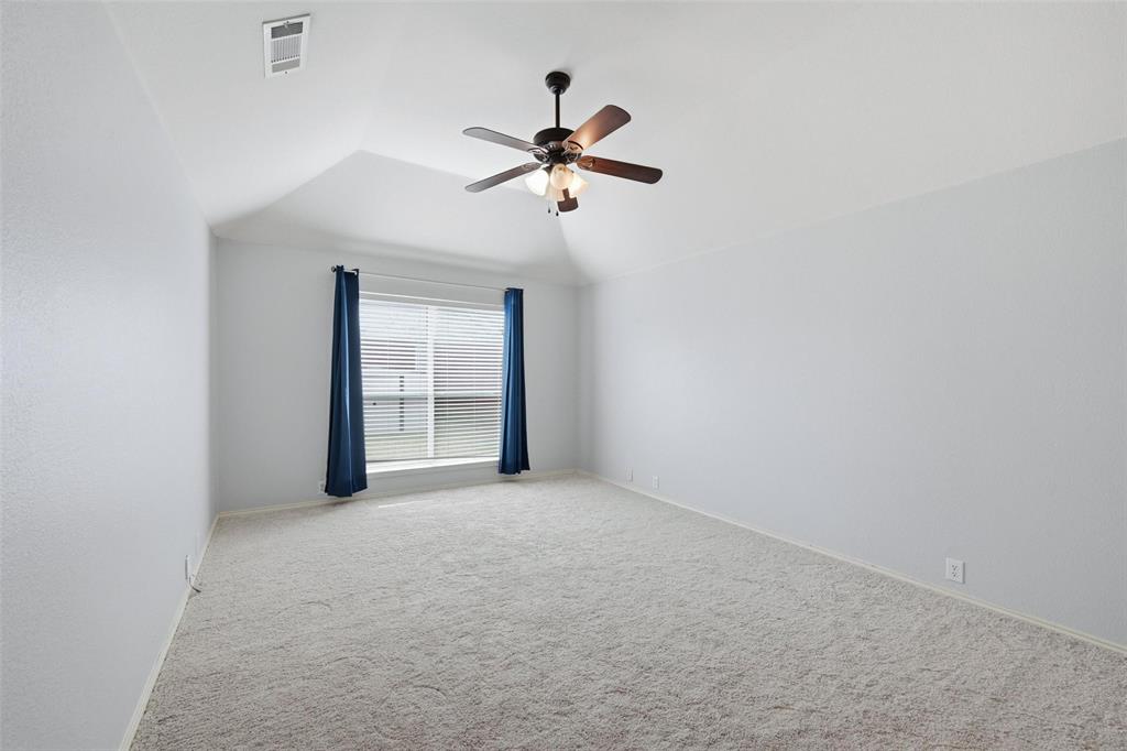1020 Hay Stack Court Little Elm, TX 75068 - Photo 12 of 20 a view of a room with a ceiling fan and a window
