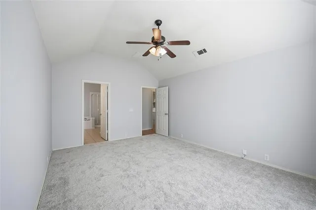 a view of empty room with ceiling fan