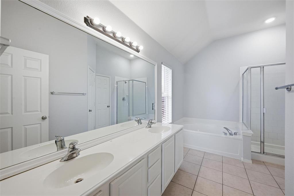1020 Hay Stack Court Little Elm, TX 75068 - Photo 14 of 20 a bathroom with a tub a sink and mirror