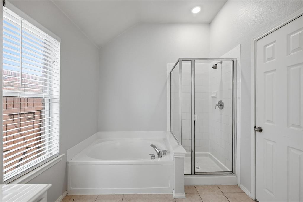 1020 Hay Stack Court Little Elm, TX 75068 - Photo 15 of 20 a bathroom with a tub a window and a shower