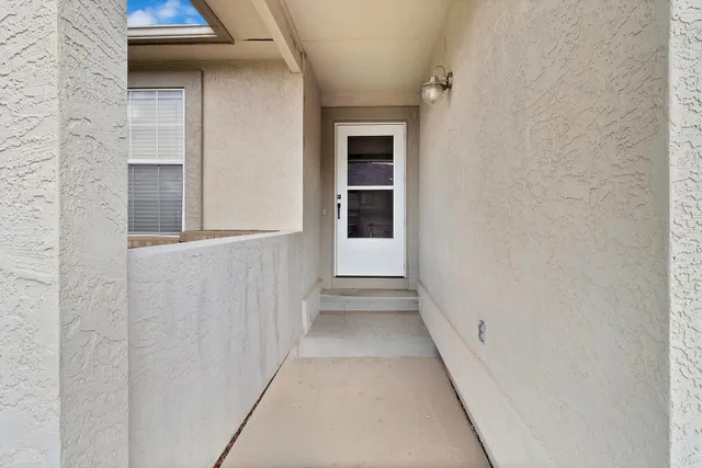 a view of a hallway with wooden floor and entryway