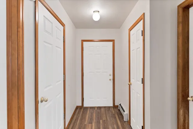 a kitchen with wooden floors and wide window