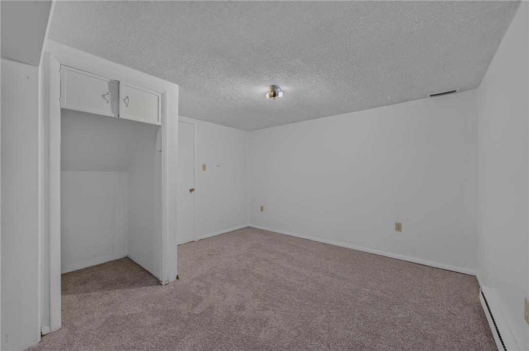 1570 Astolat Road Effort, PA 18330 - Photo 9 of 48 An open alcove with overhead cabinets and plush carpeting details this versatile room.