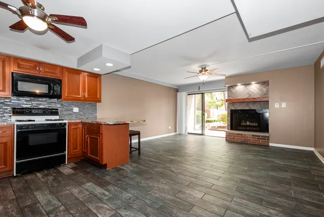 a kitchen with stainless steel appliances a stove top oven a sink and a microwave