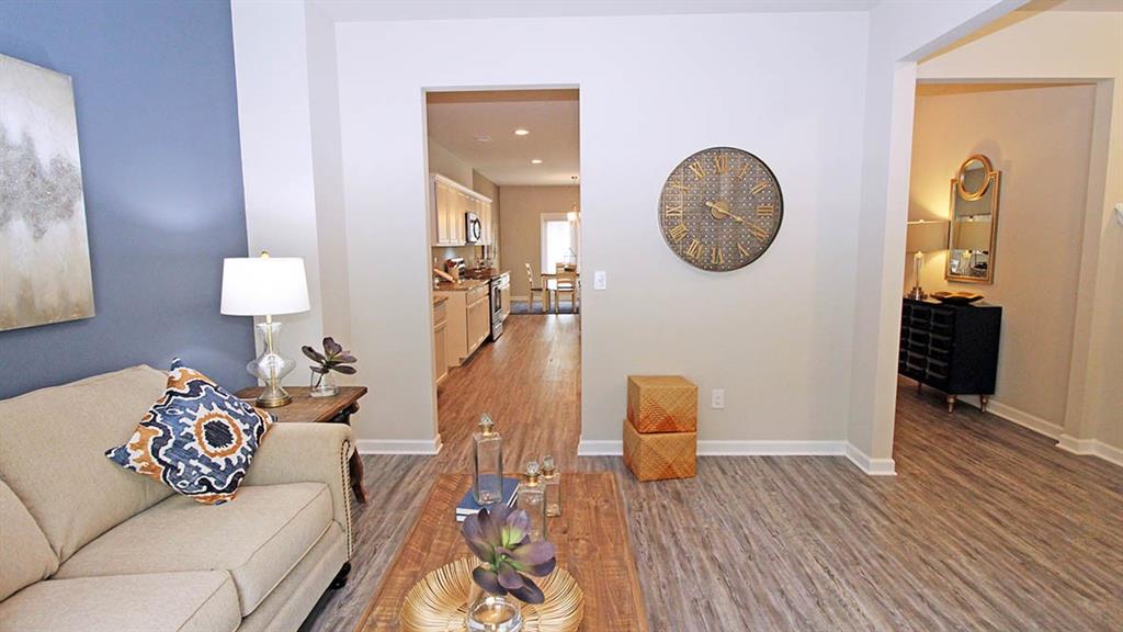 328 Bullock Pass Jefferson, GA 30549 - Photo 11 of 23 a living room with furniture a mirror and wooden floor
