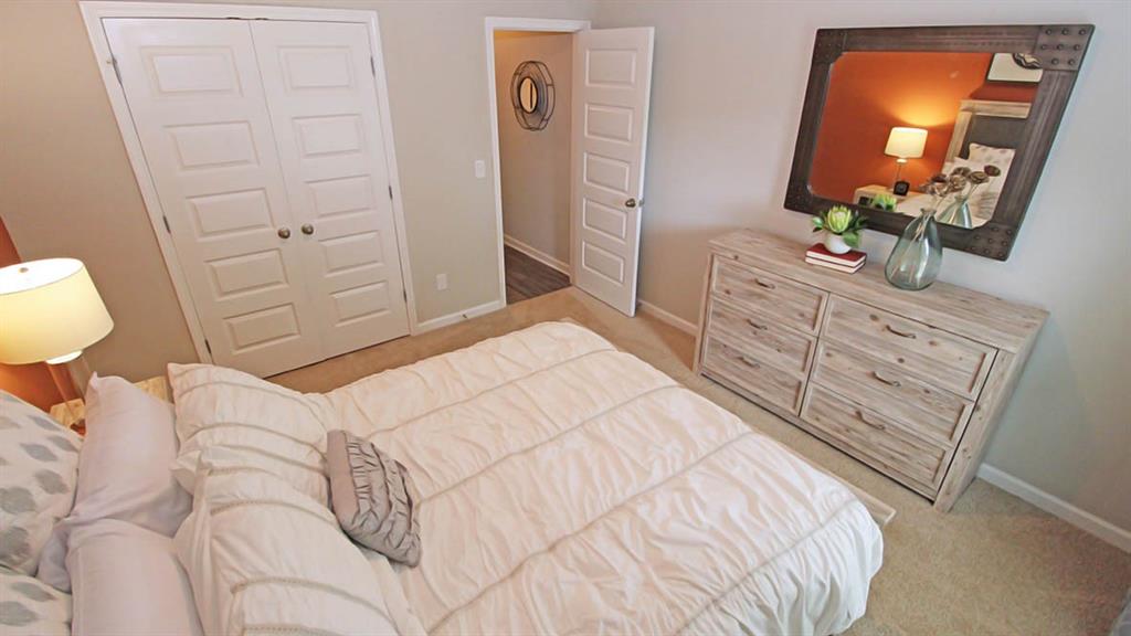 328 Bullock Pass Jefferson, GA 30549 - Photo 13 of 23 a bedroom with a bed and a dresser