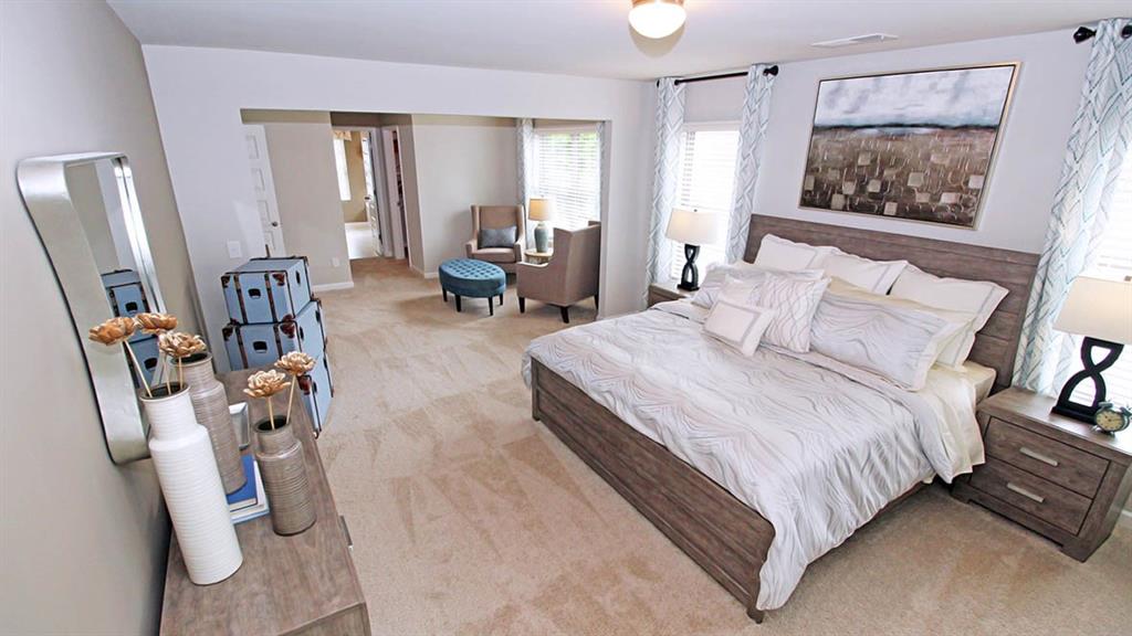 328 Bullock Pass Jefferson, GA 30549 - Photo 16 of 23 a bedroom with bed and a flat tv screen on dresser