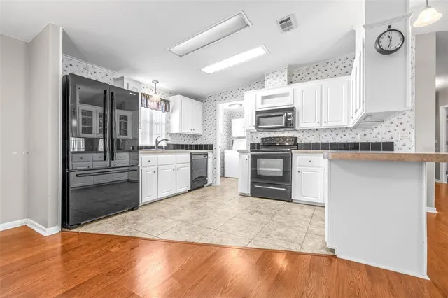 a kitchen with stainless steel appliances granite countertop a stove top oven and sink