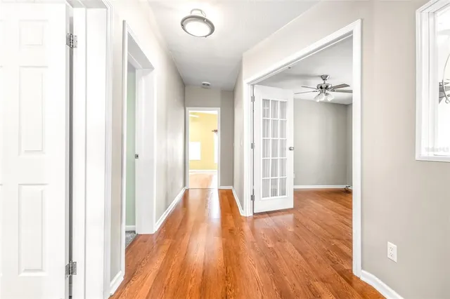 a view of a hallway with wooden floor