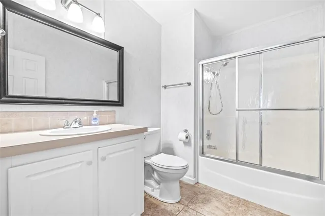 a bathroom with a toilet a sink and a mirror