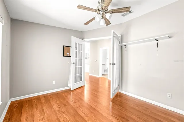 a view of a big room with wooden floor closet and entryway