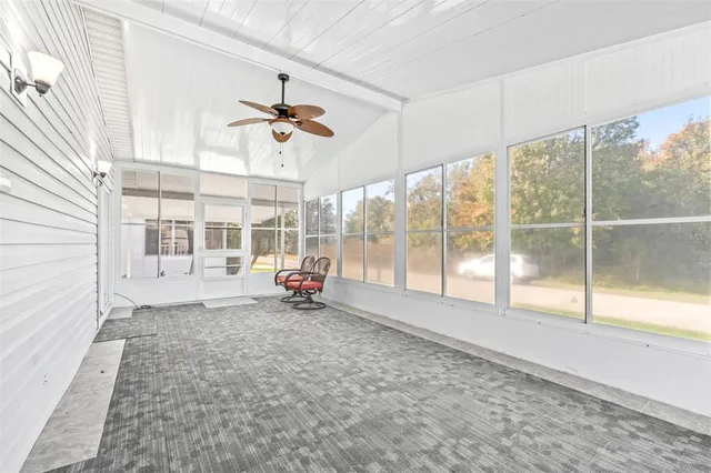 a view of a livingroom with a ceiling fan and a window