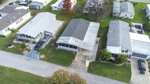 an aerial view of a house with garden space and street view